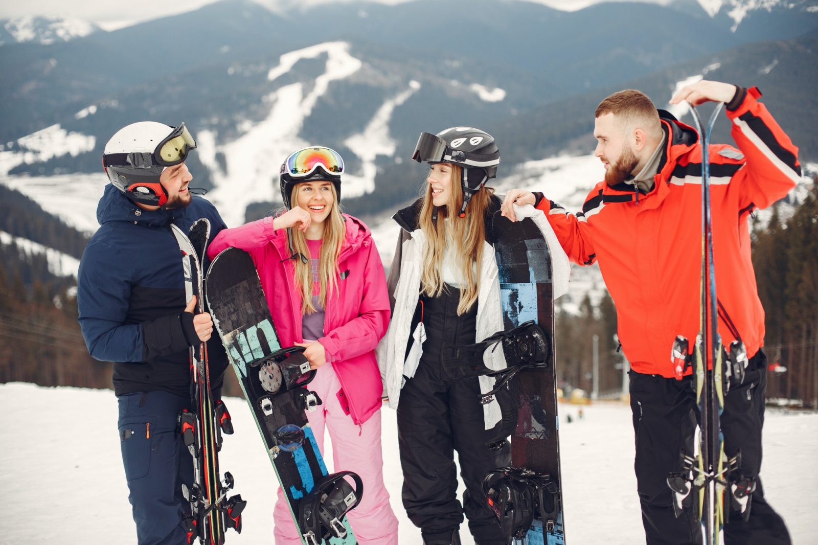 People snowboarding in the mountains with the snowboard