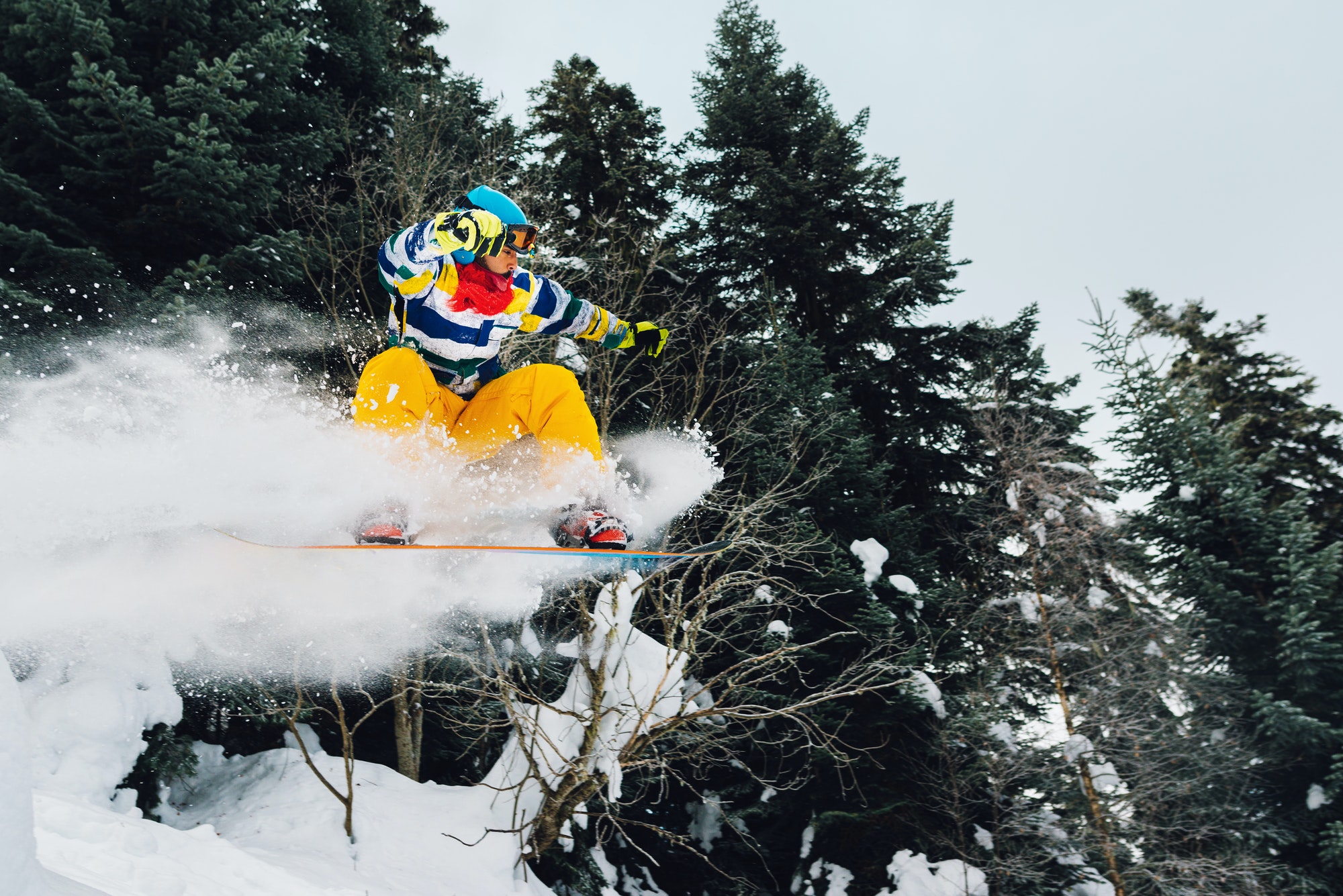 snowboarder is jumping and freeridingin the mountain forest